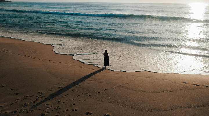 person-standing-at-shoreline-on-beach