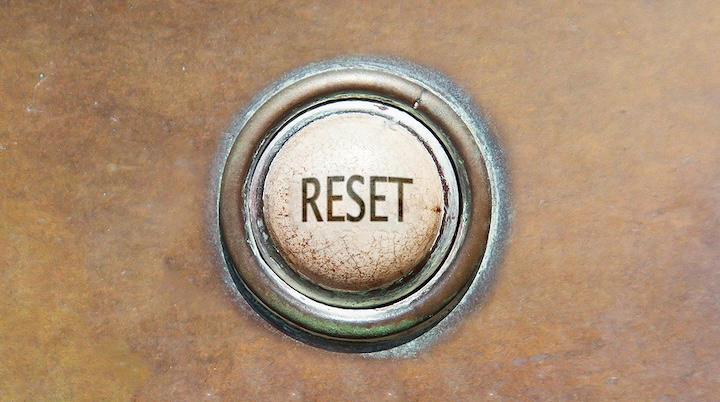 Button with the word "reset" on it set into brown surface