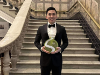 Jason Le holding the Nick Xynias Multicultural Business Person of the Year Award