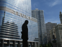 Silhouette of a statue outside a Trump tower