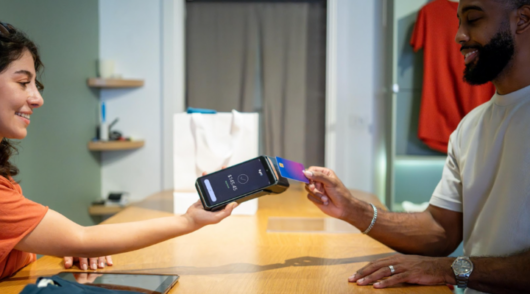 Man paying by card at shop