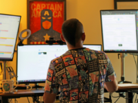 A man working on multiple screens.